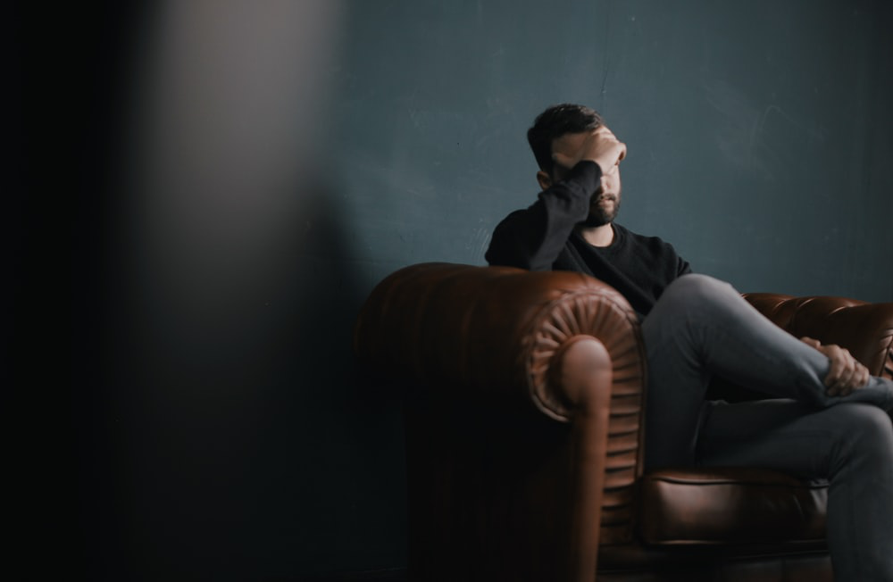 A person with PTSD sitting on a chair