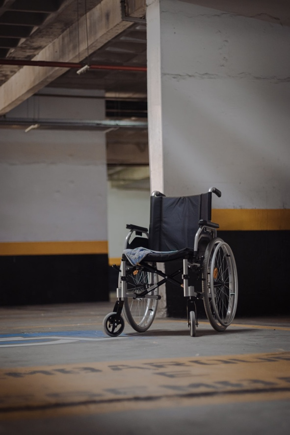 An empty wheel chair in a parking lot 